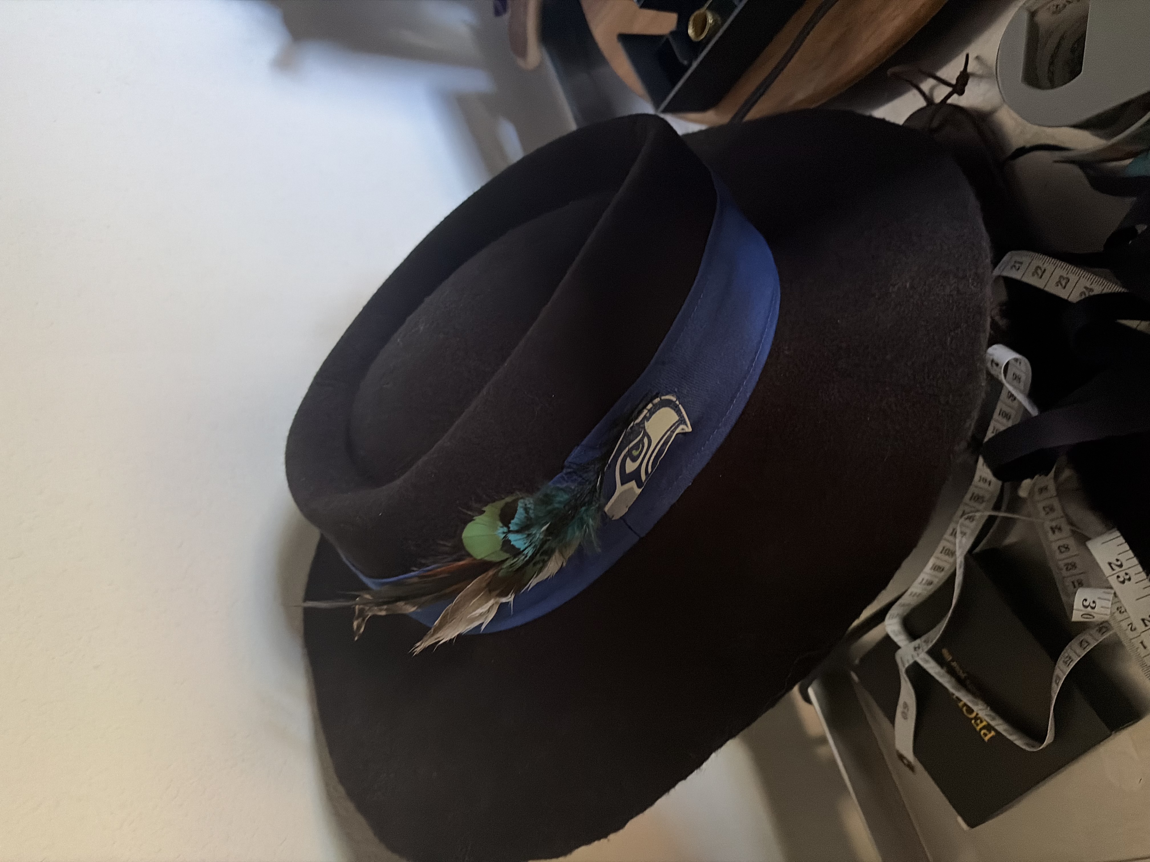 Custom dark felt hat with a feathered band