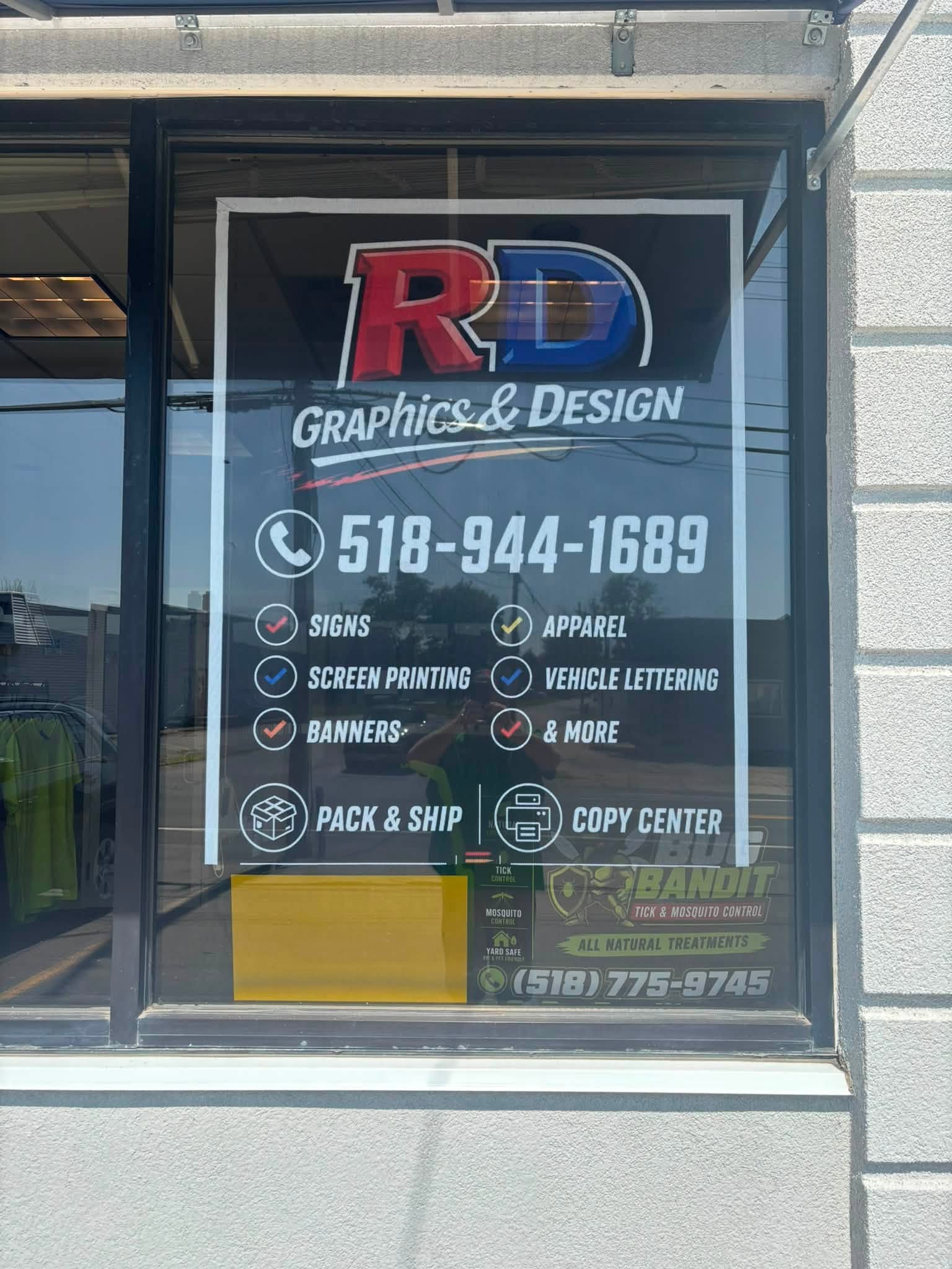 RD Graphics & Design shop door sign listing Pack & Ship and Copy Center services