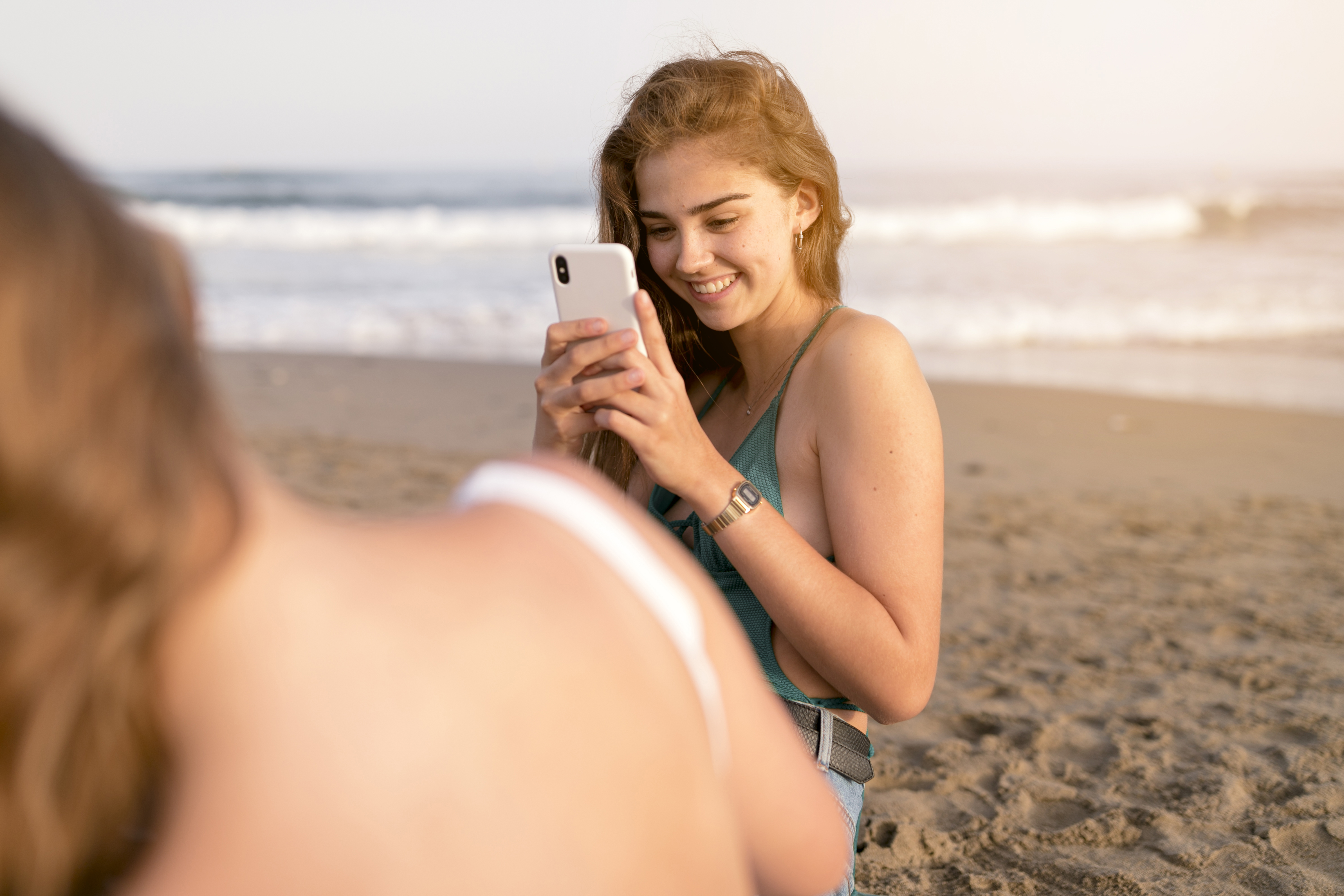 a lady taking self portrait of her lesbian lover on a beach