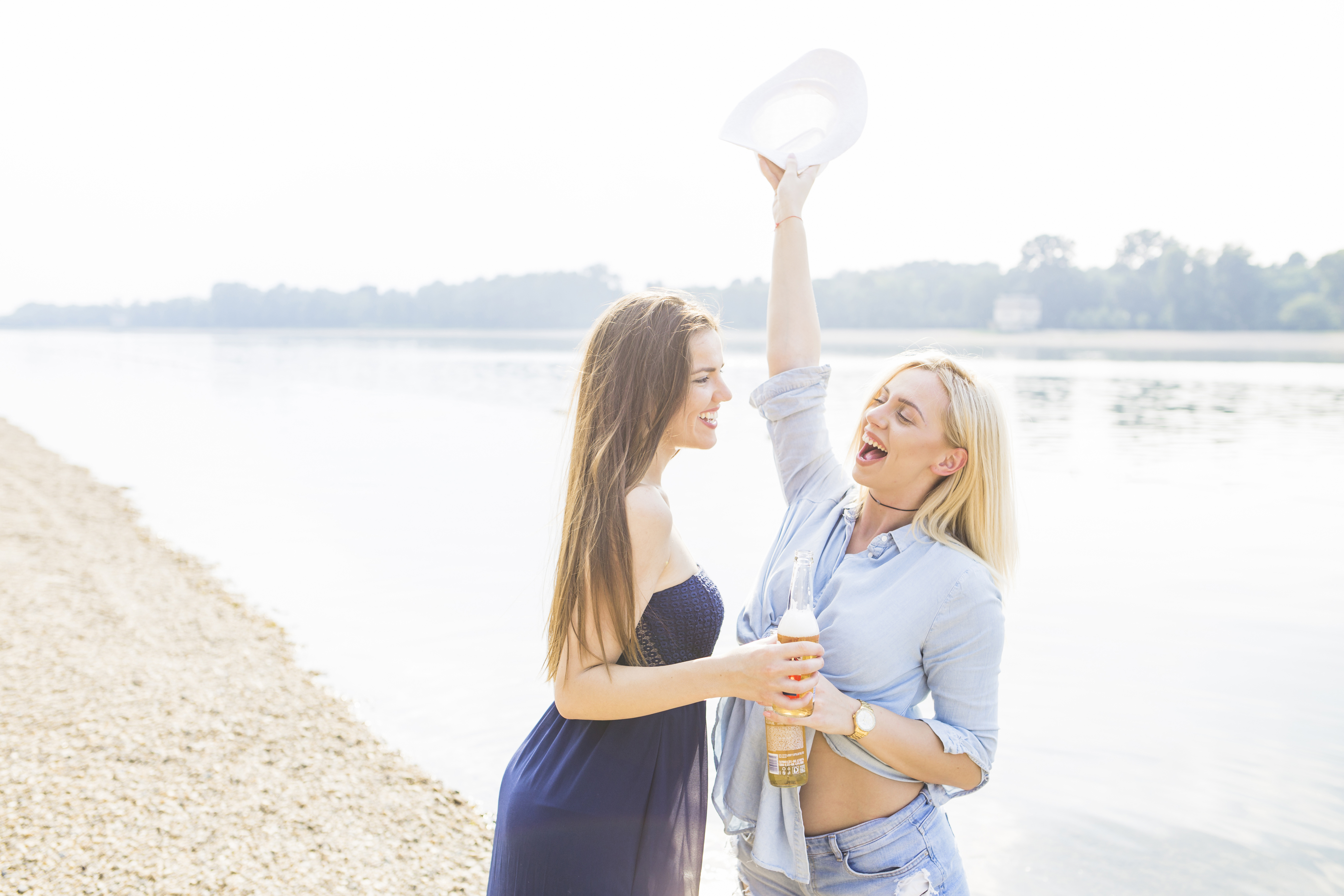 Smiling young lesbian couple enjoying on the beach