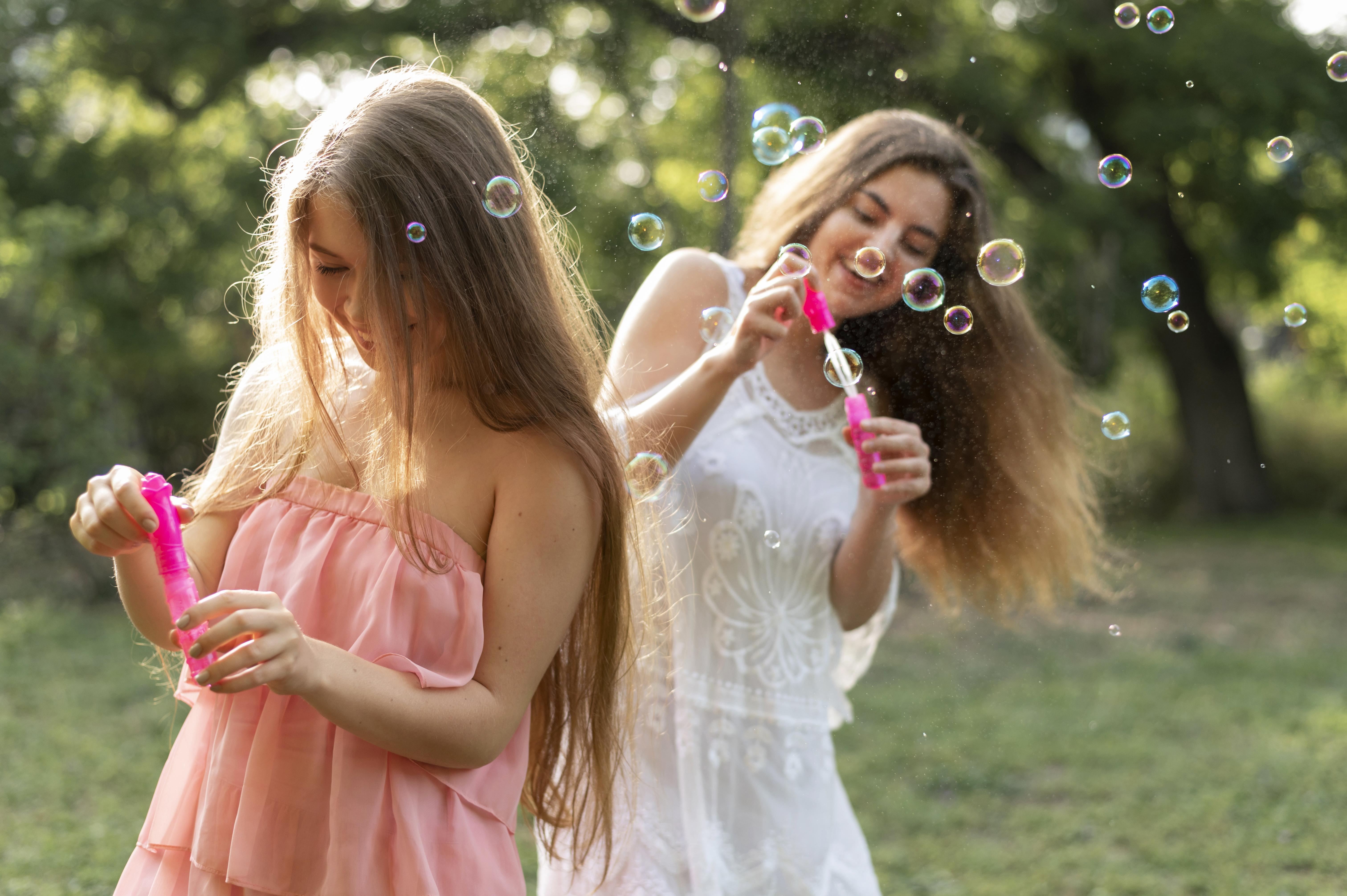 beautiful lesbian couple playing bubbles