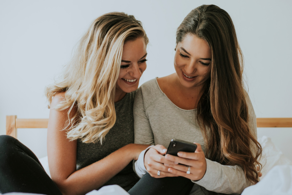lesbian showing her lover her phone