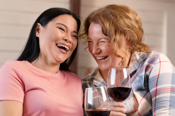 lesbian couple drinking red wine