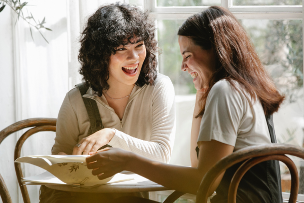 lesbian couple flipping the menu together