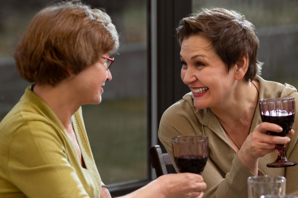 mature lesbian couple drinking wine together