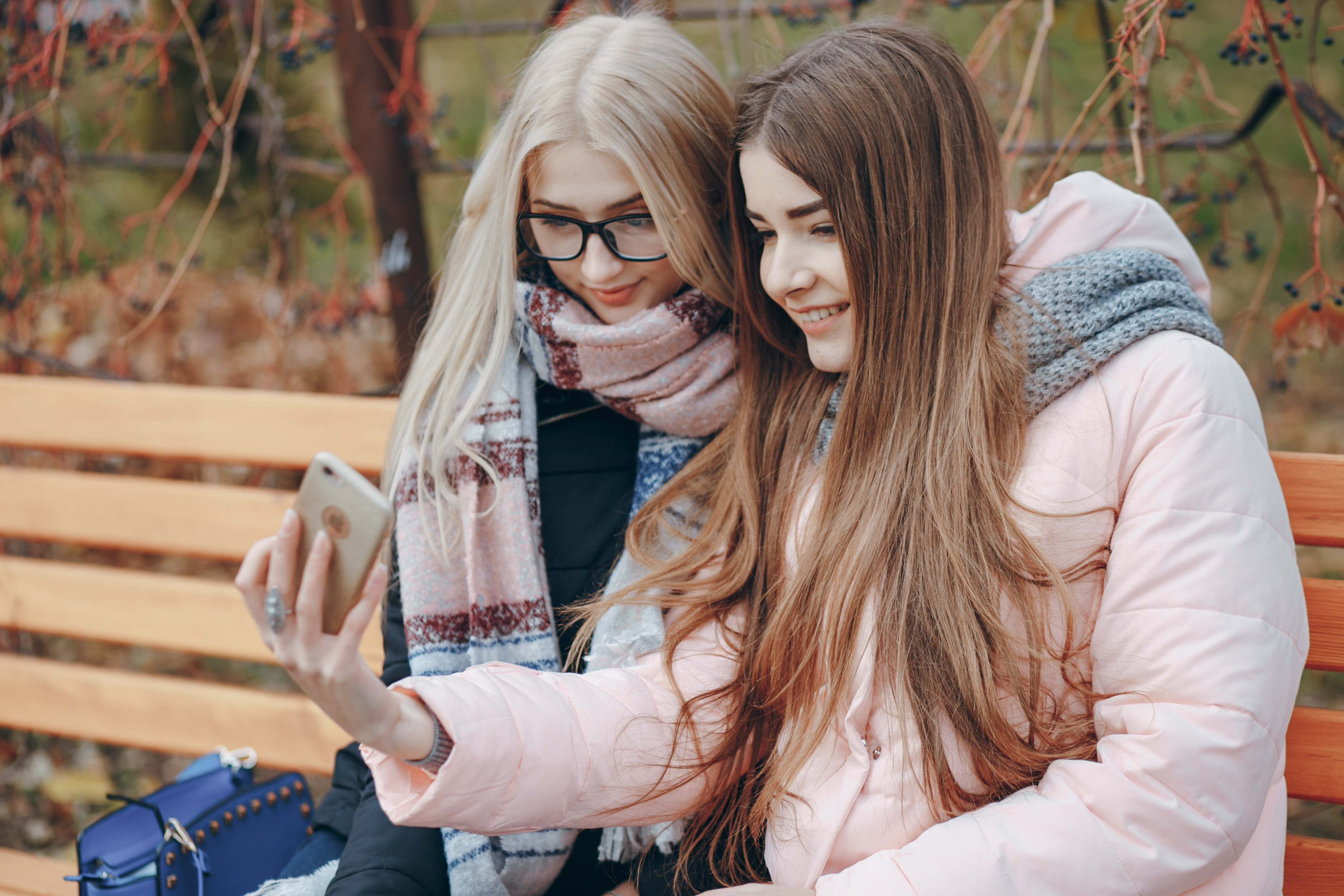 lesbian lovers taking a selfie at the park
