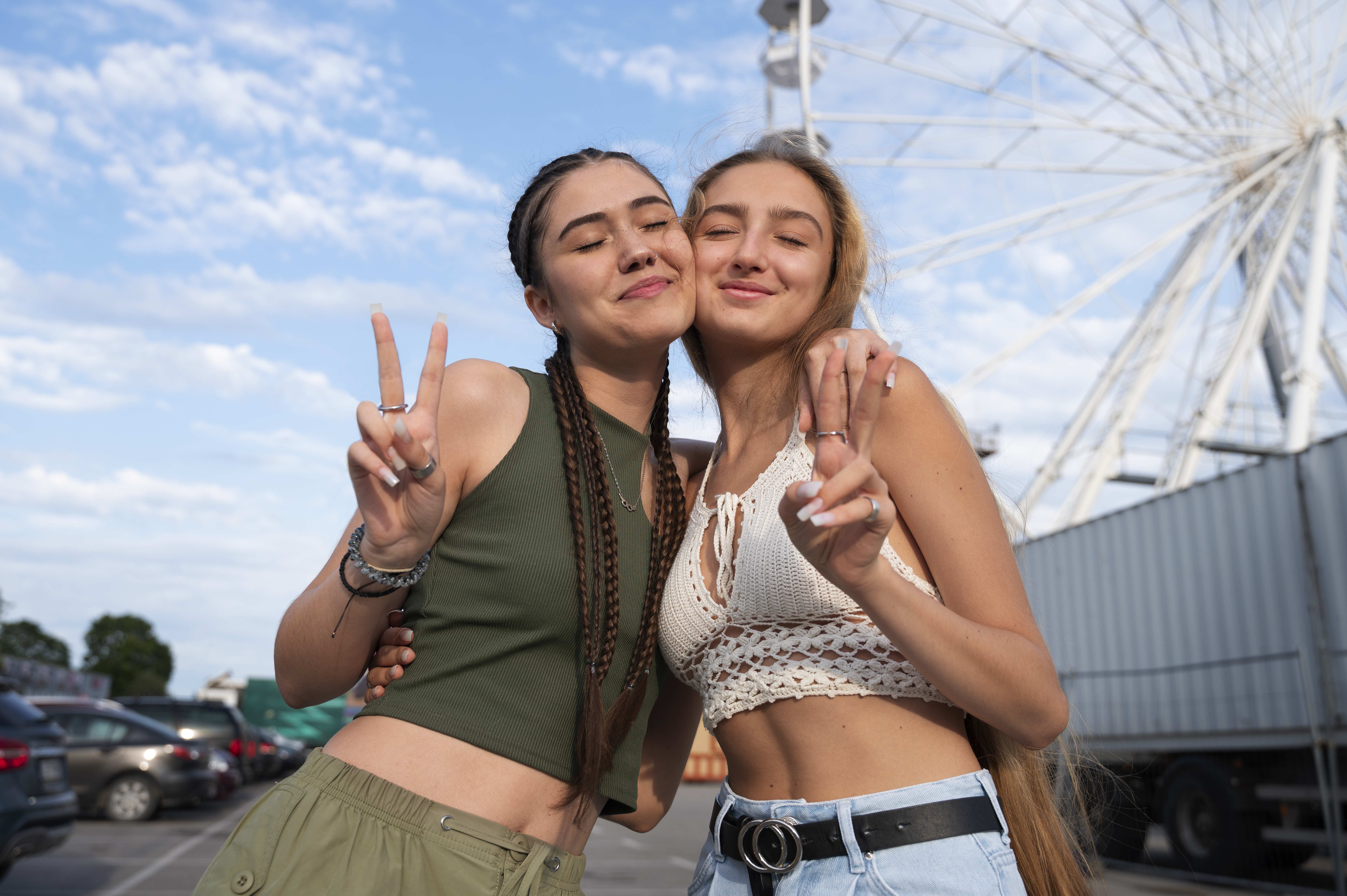 lesbian couple making a hand gesture together