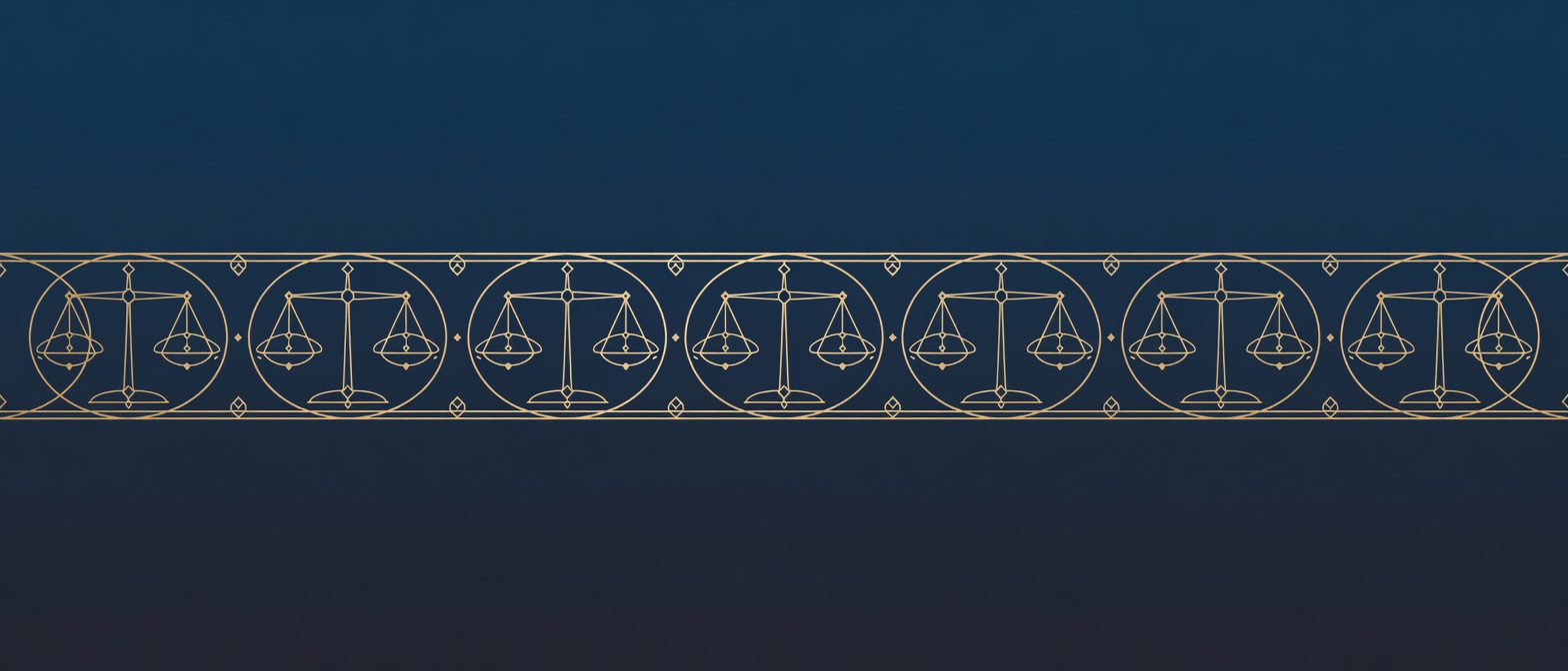 A wide engraved frieze of balance scales and orbital rings as an ornamental section break