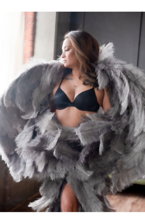 woman in black bra, wearing grey angel wings