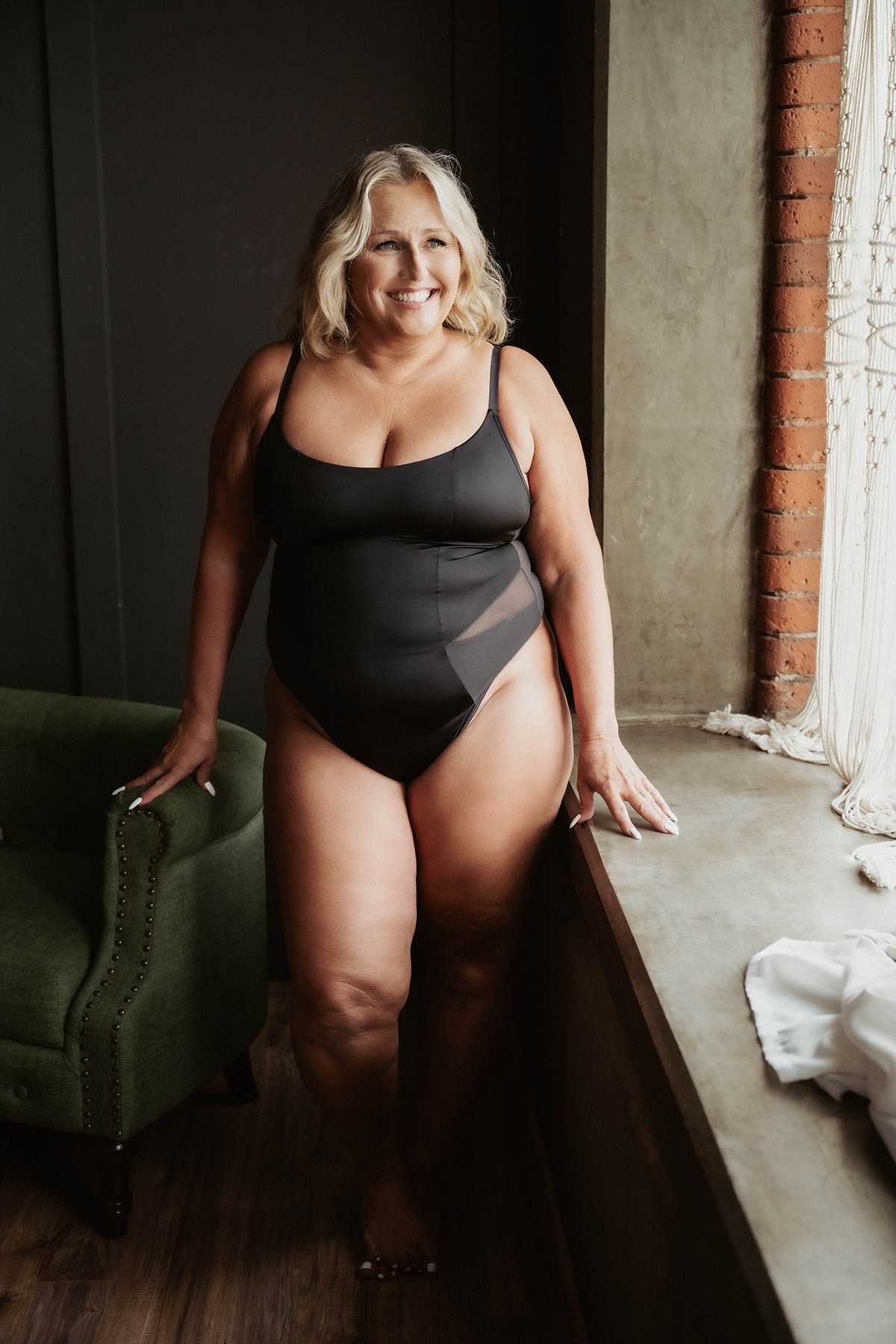 woman looking up while wearing black lingerie