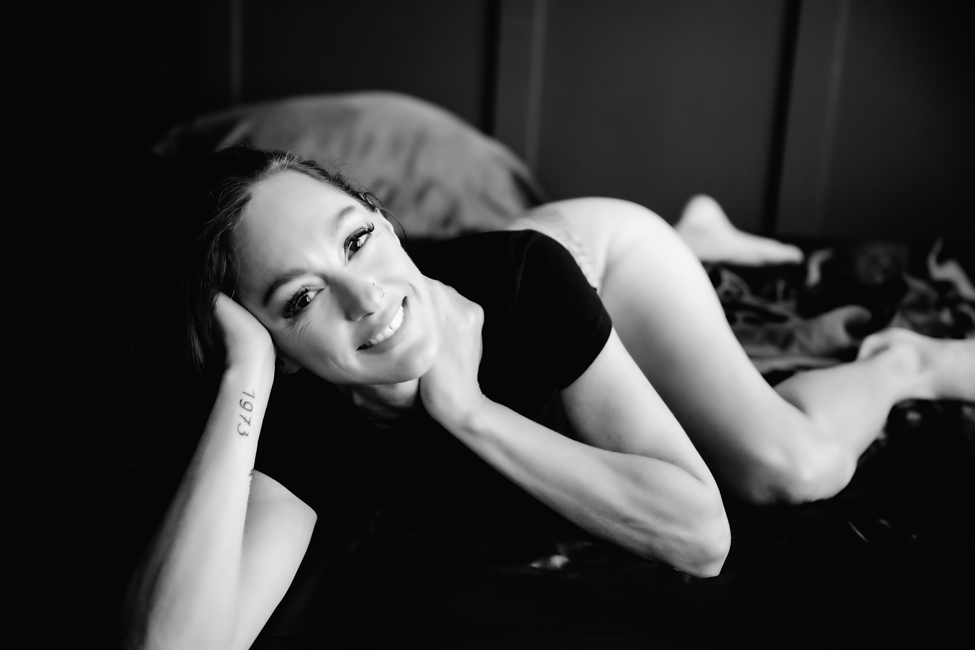 woman looking up while wearing black lingerie