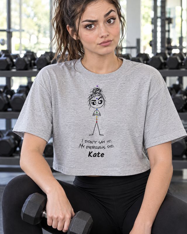 A woman at the gym in a grey I didn't say it, my eyebrows did boxy tee with the name Kate