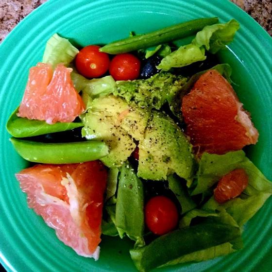 Grapefruit and avocado salad on a turquoise plate