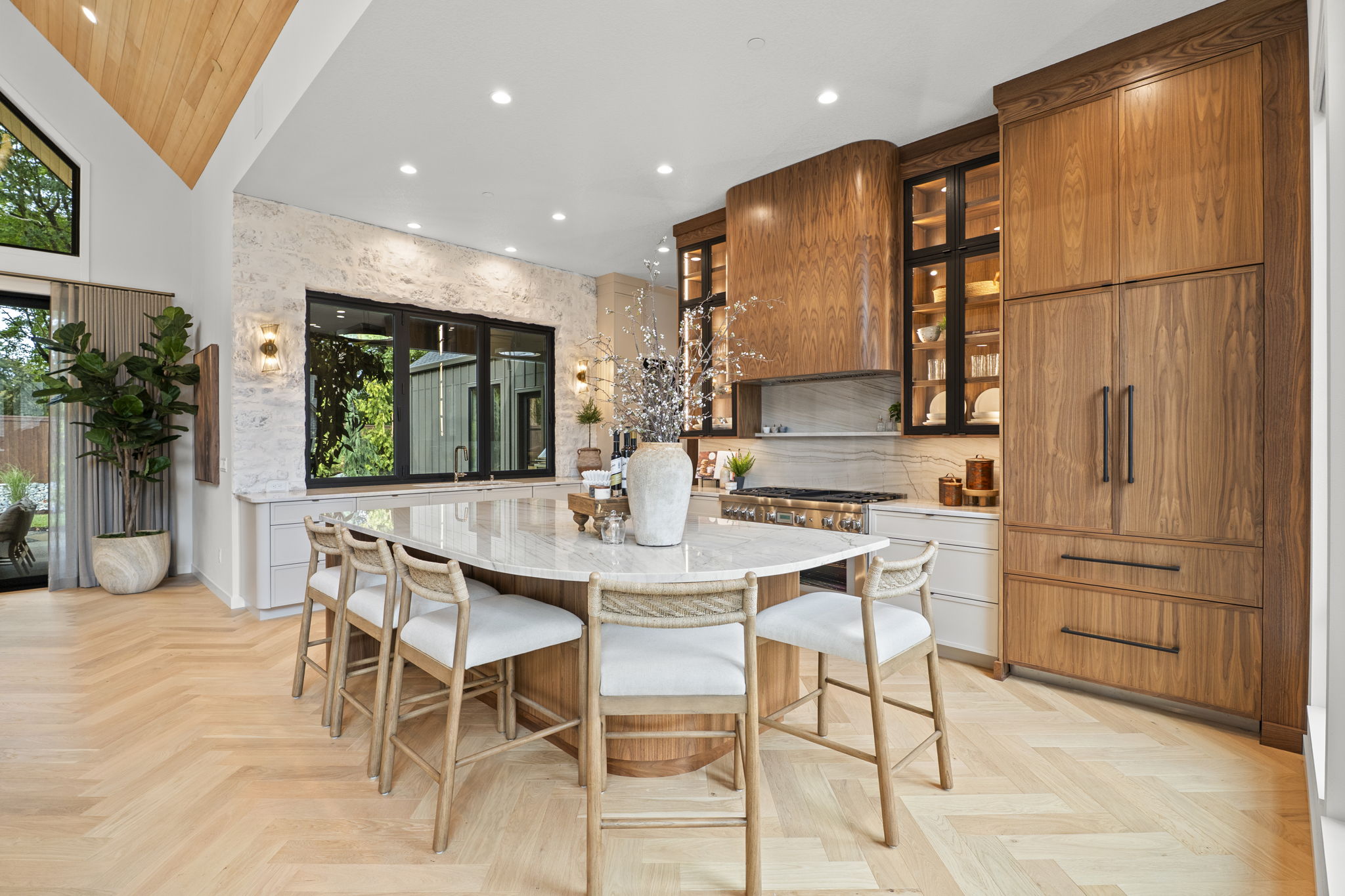 Dining area with warm wood cabinetry and garden view