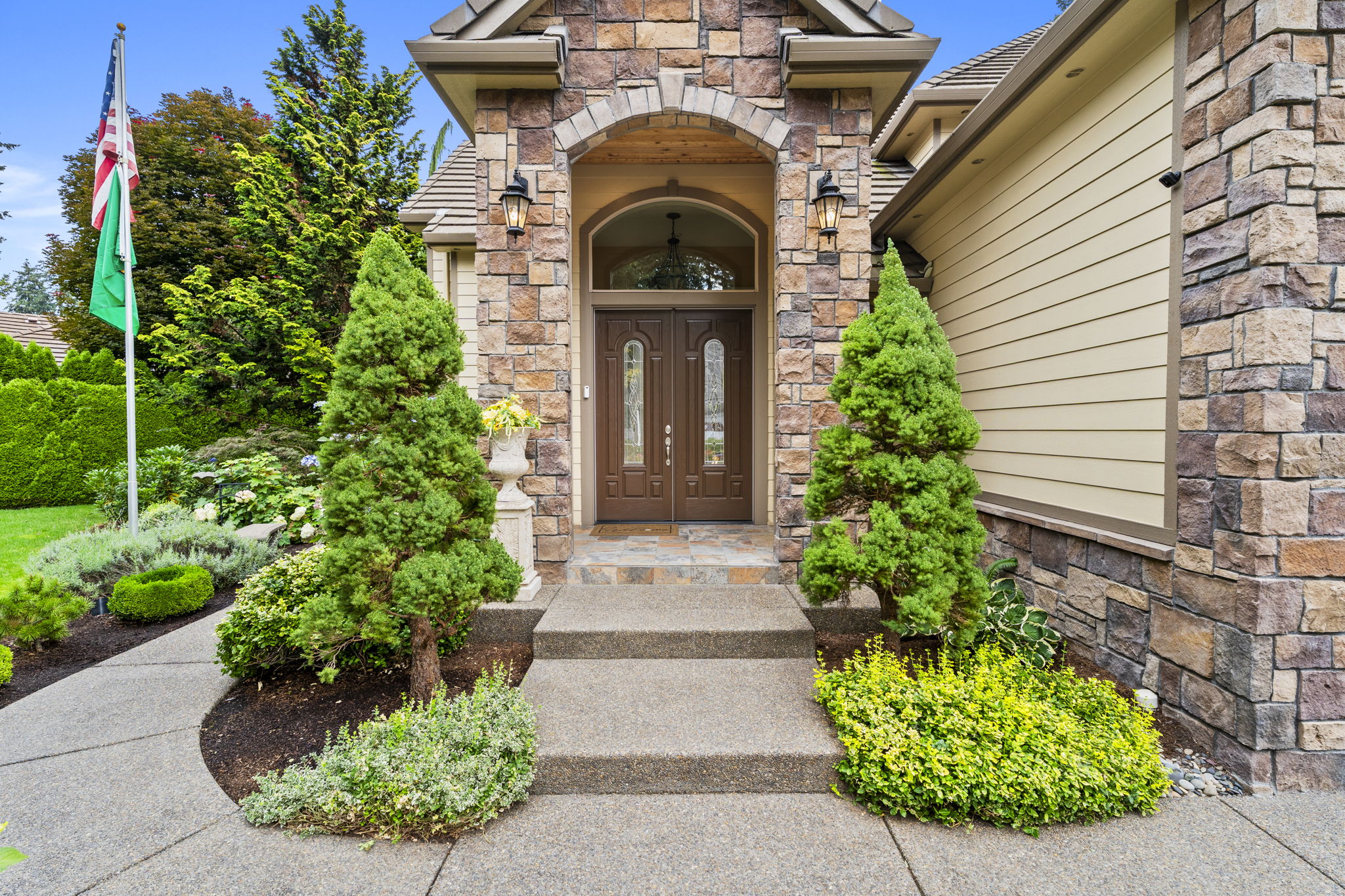 Stone entry and landscaping at the front of a home