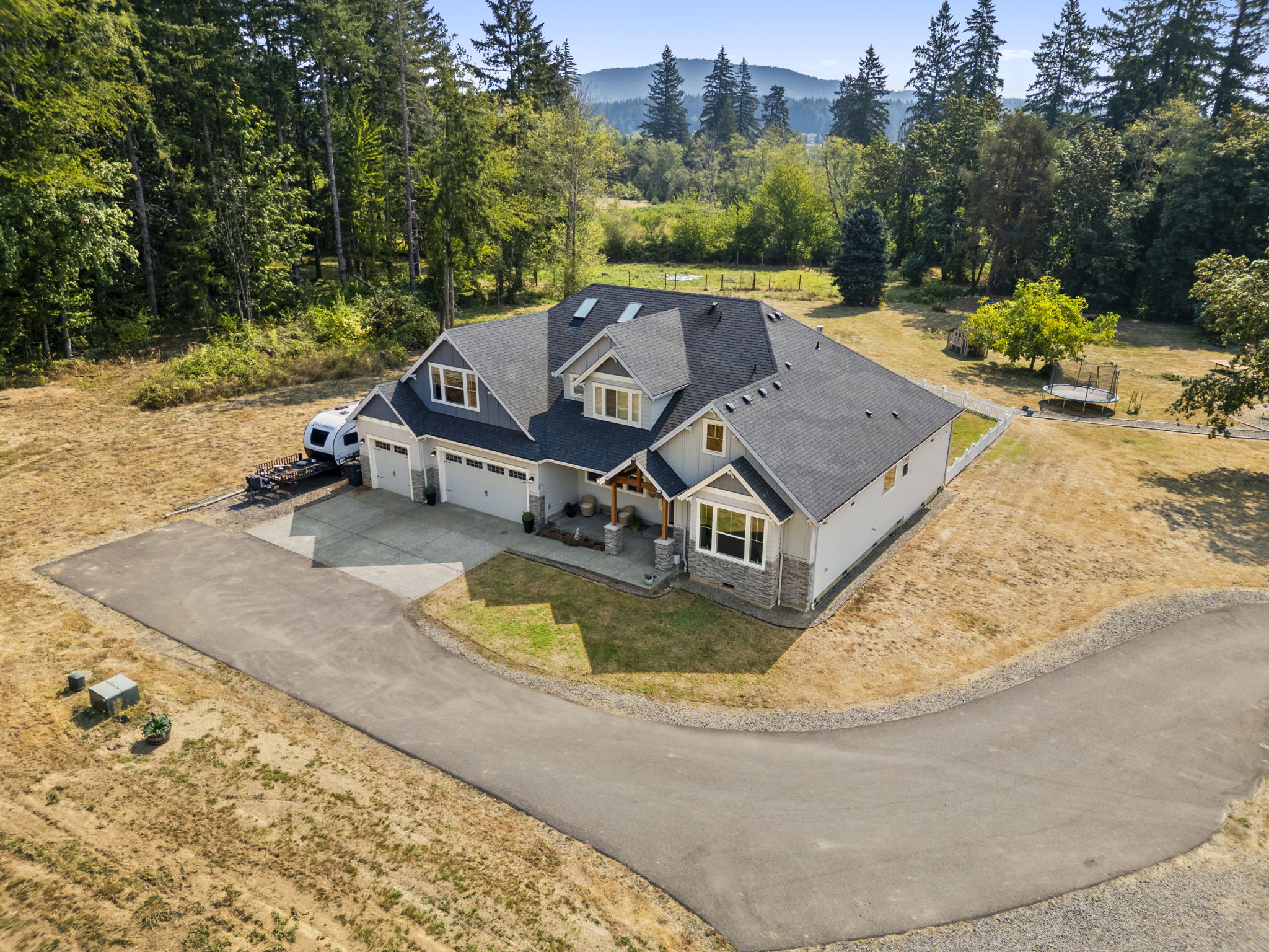 Aerial view of home on a private lot with driveway