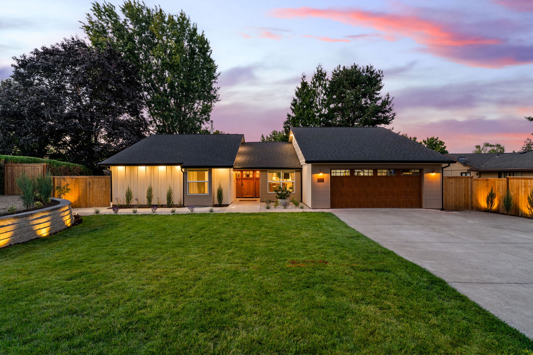Home with warm lights under a pink and blue twilight sky