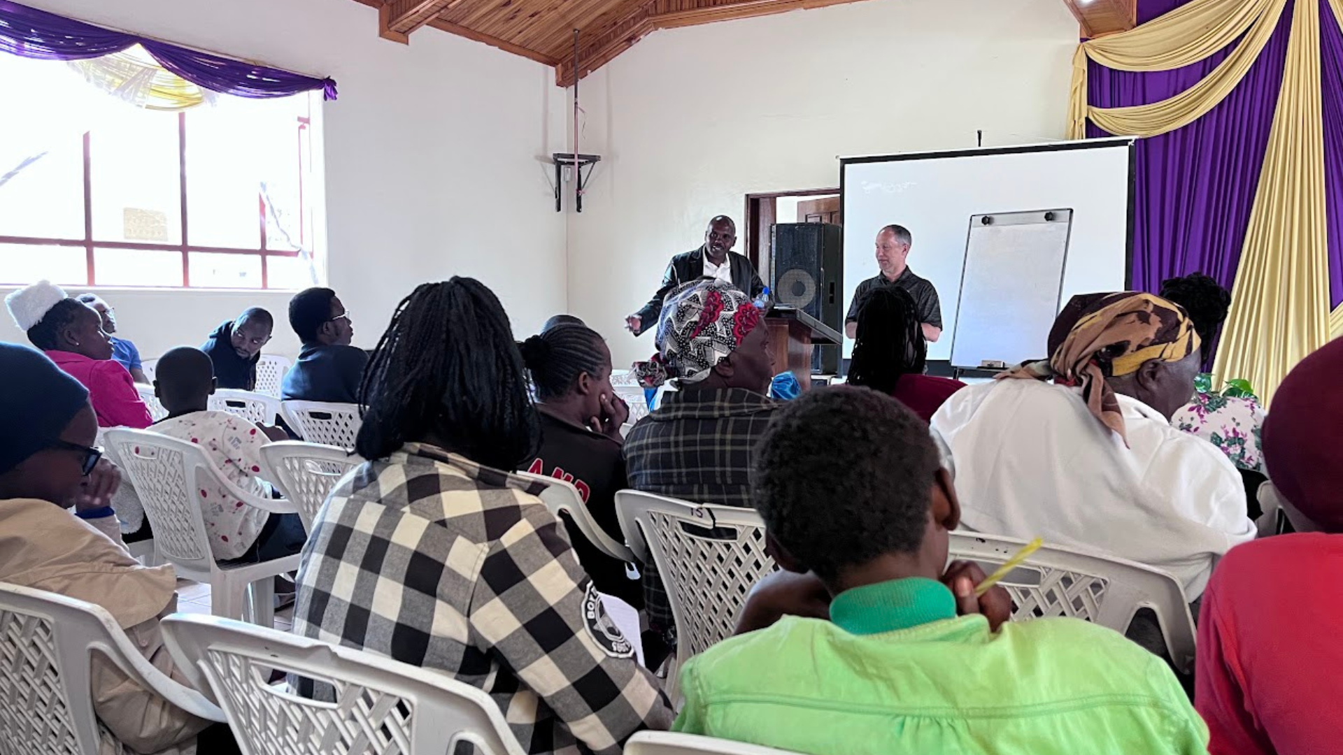 Women and community members standing together during Lulu Thamani work in Kenya