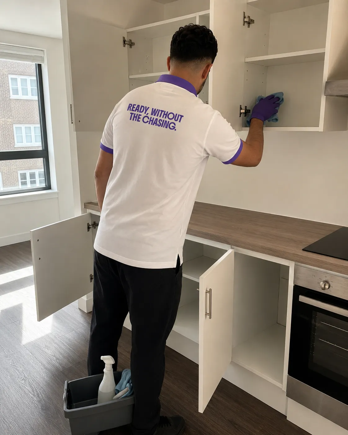 KeepReady professional deep cleaning inside empty kitchen cabinets during an end-of-tenancy clean in Birmingham