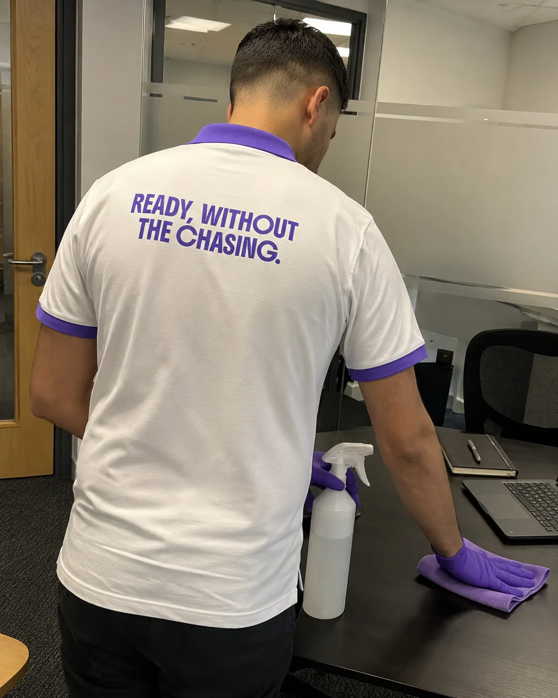 KeepReady professional disinfecting a corporate office desk, reflecting the brand principle of owning the outcome