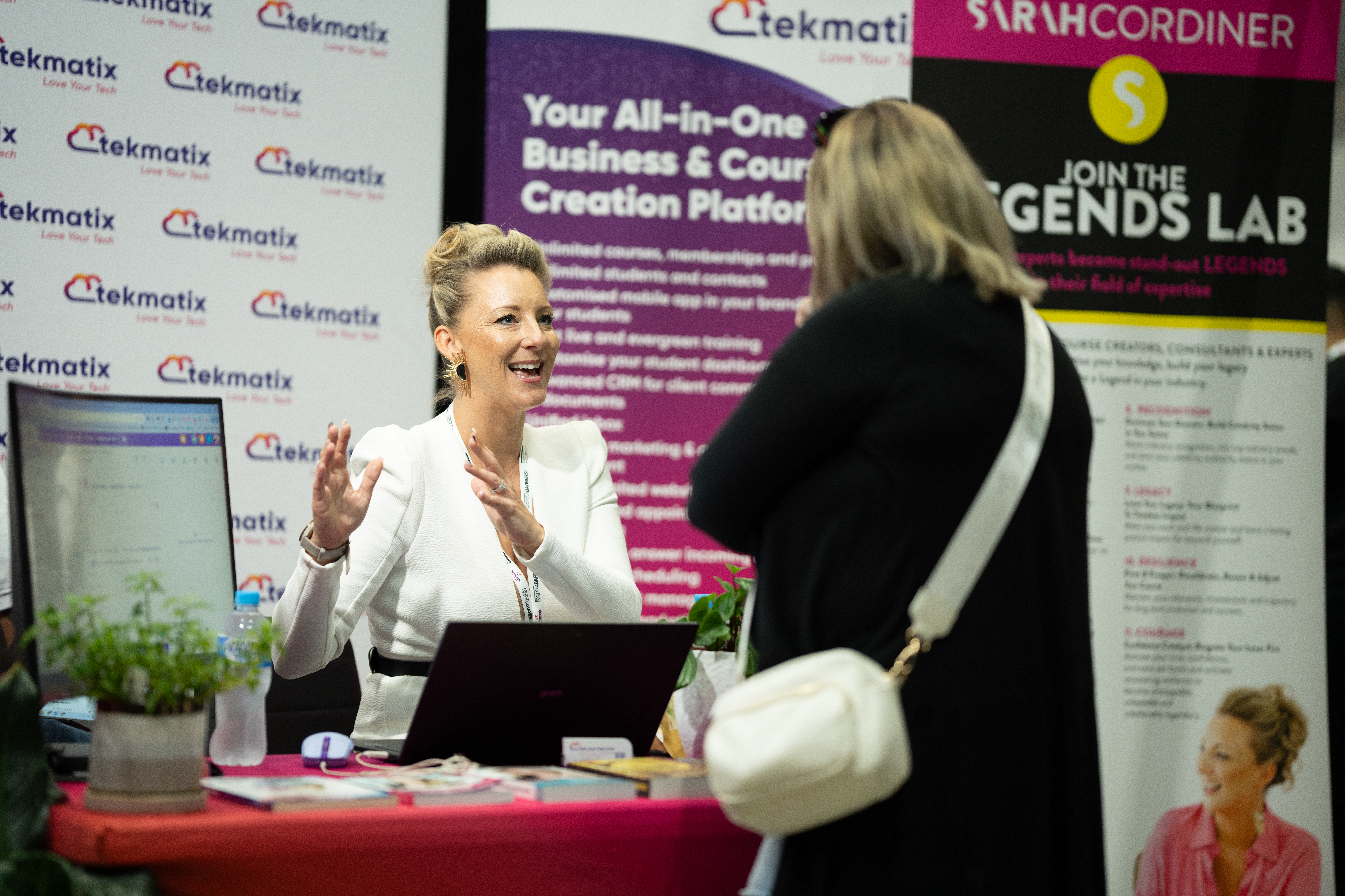 Sarah Cordiner talking with a business owner at her Tekmatix and Legends Lab stand