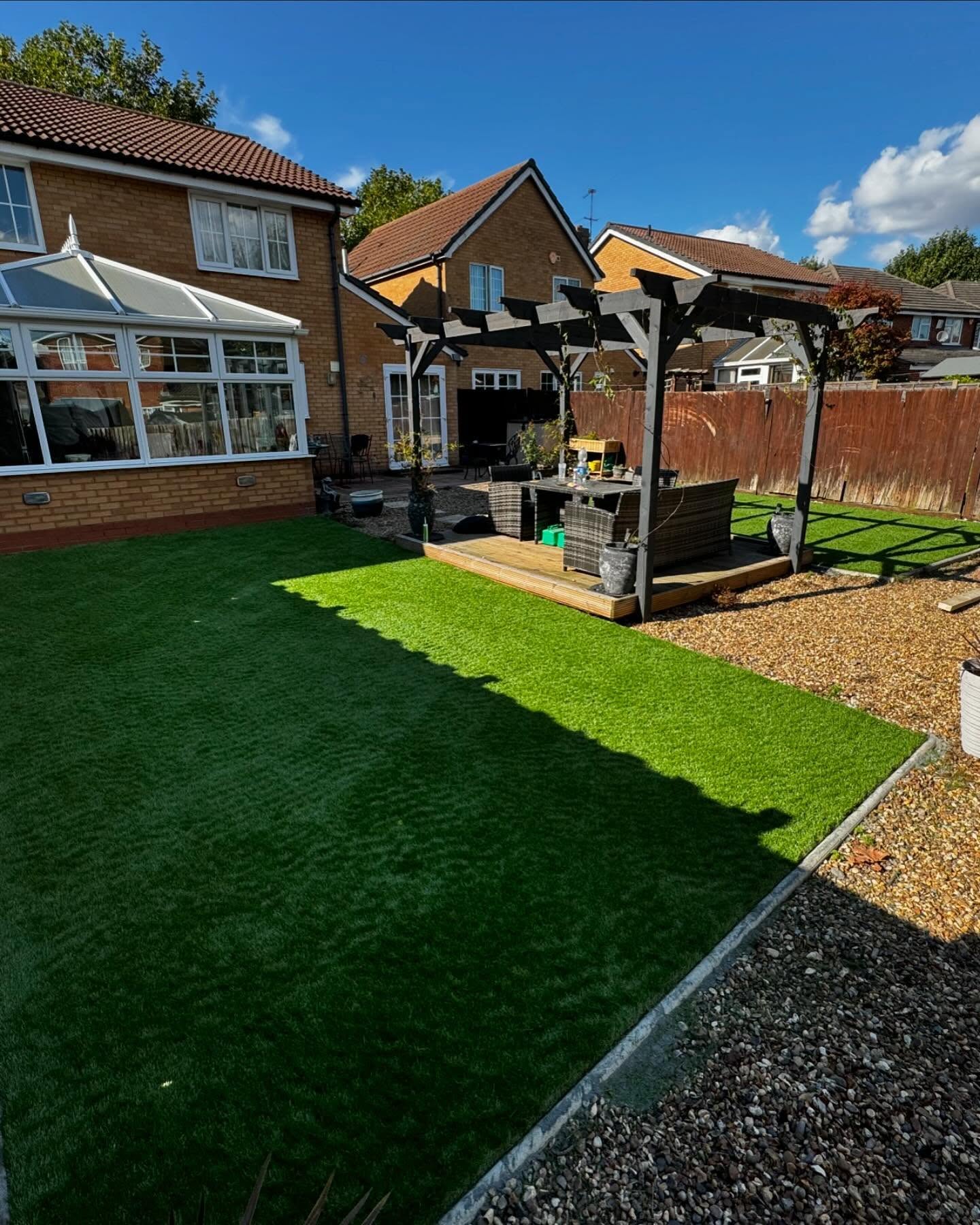 Garden with pergola, decking and lawn