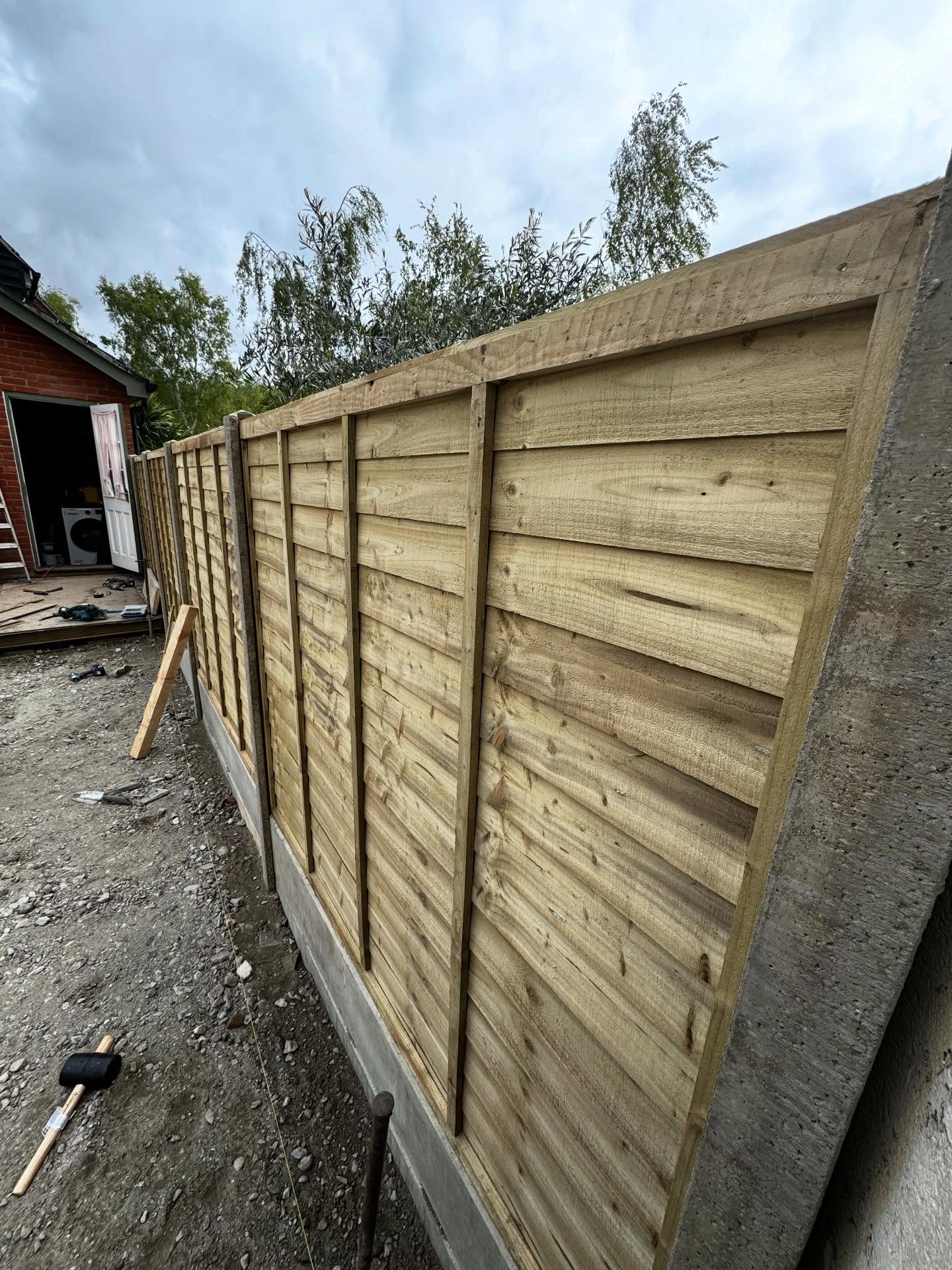 New timber fence panel installation