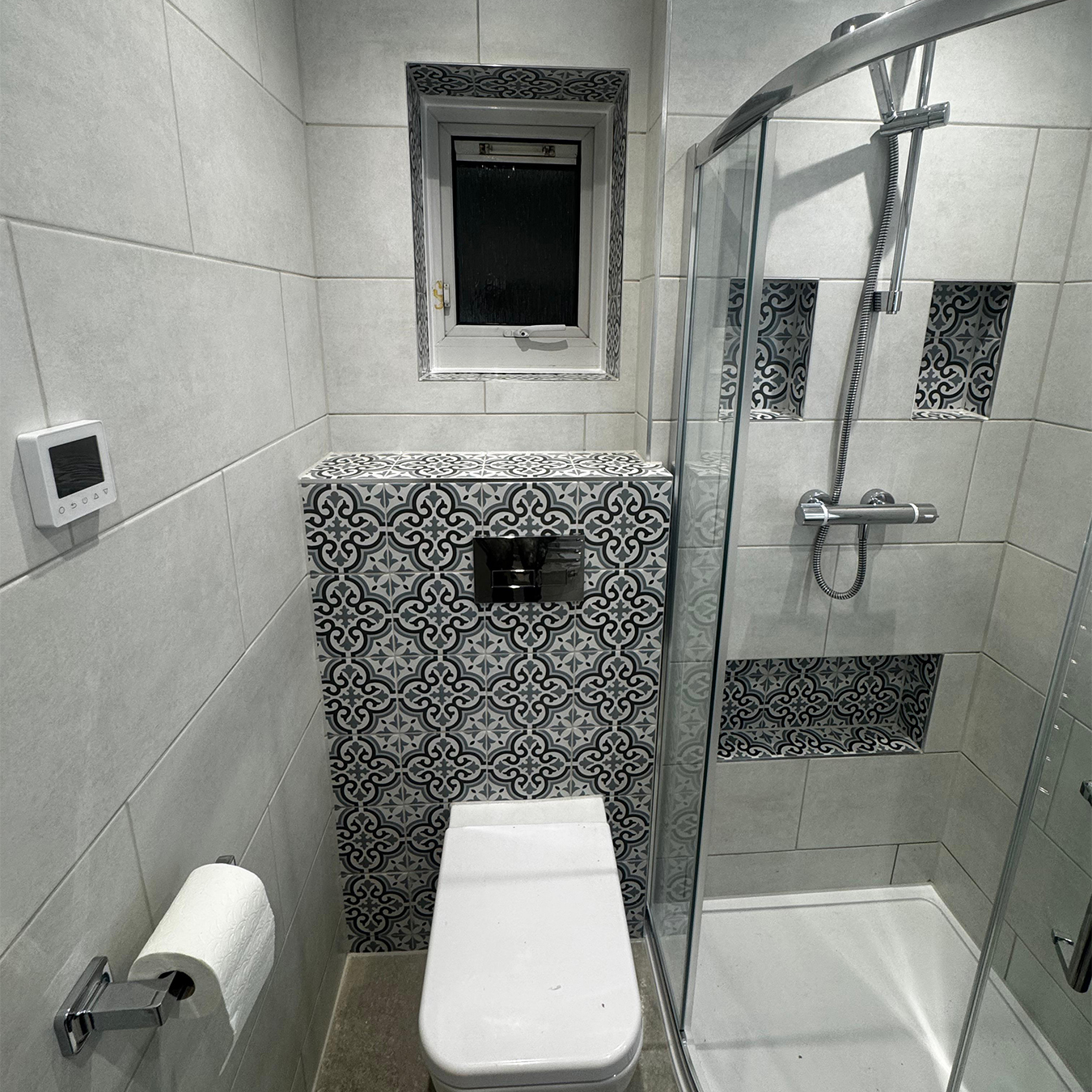 Ensuite bathroom with patterned tile and walk-in shower