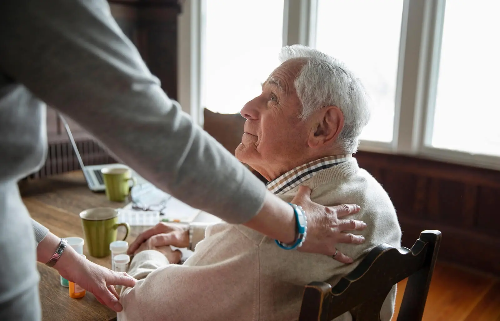 An Apex carer visiting a client at home in Reading, sitting together in the front room