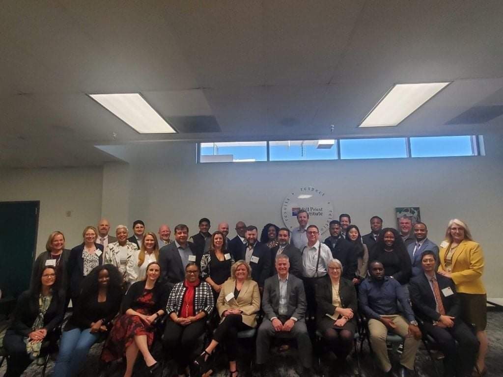 Ieshea Hollins with a large cybersecurity training cohort at the Bill J. Priest Institute