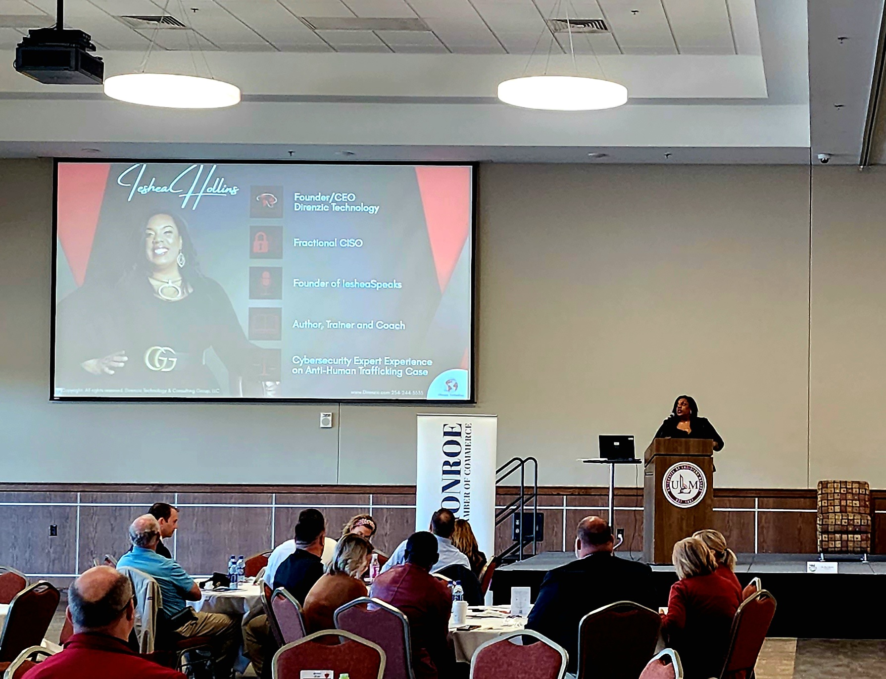 Ieshea Hollins delivering a keynote at the University of Louisiana at Monroe with her branded presentation on screen