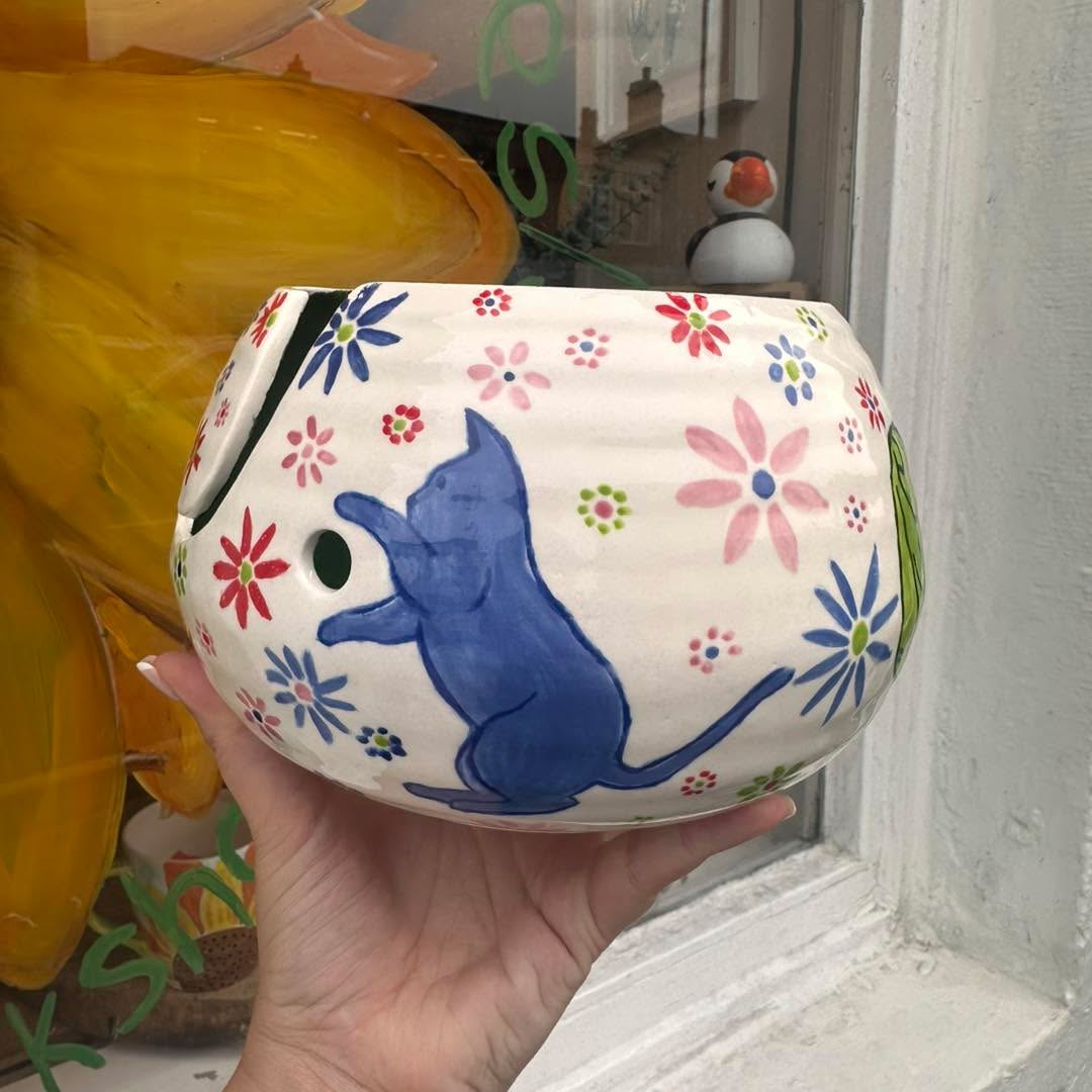 Pottery painting studio with colourful pieces at Puffin Pottery