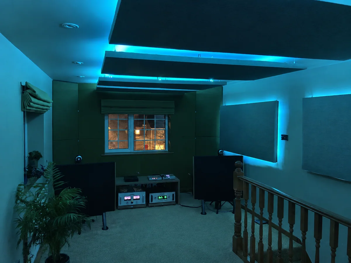 Sound-absorbing wall and ceiling panels fitted in a music room with blue backlighting