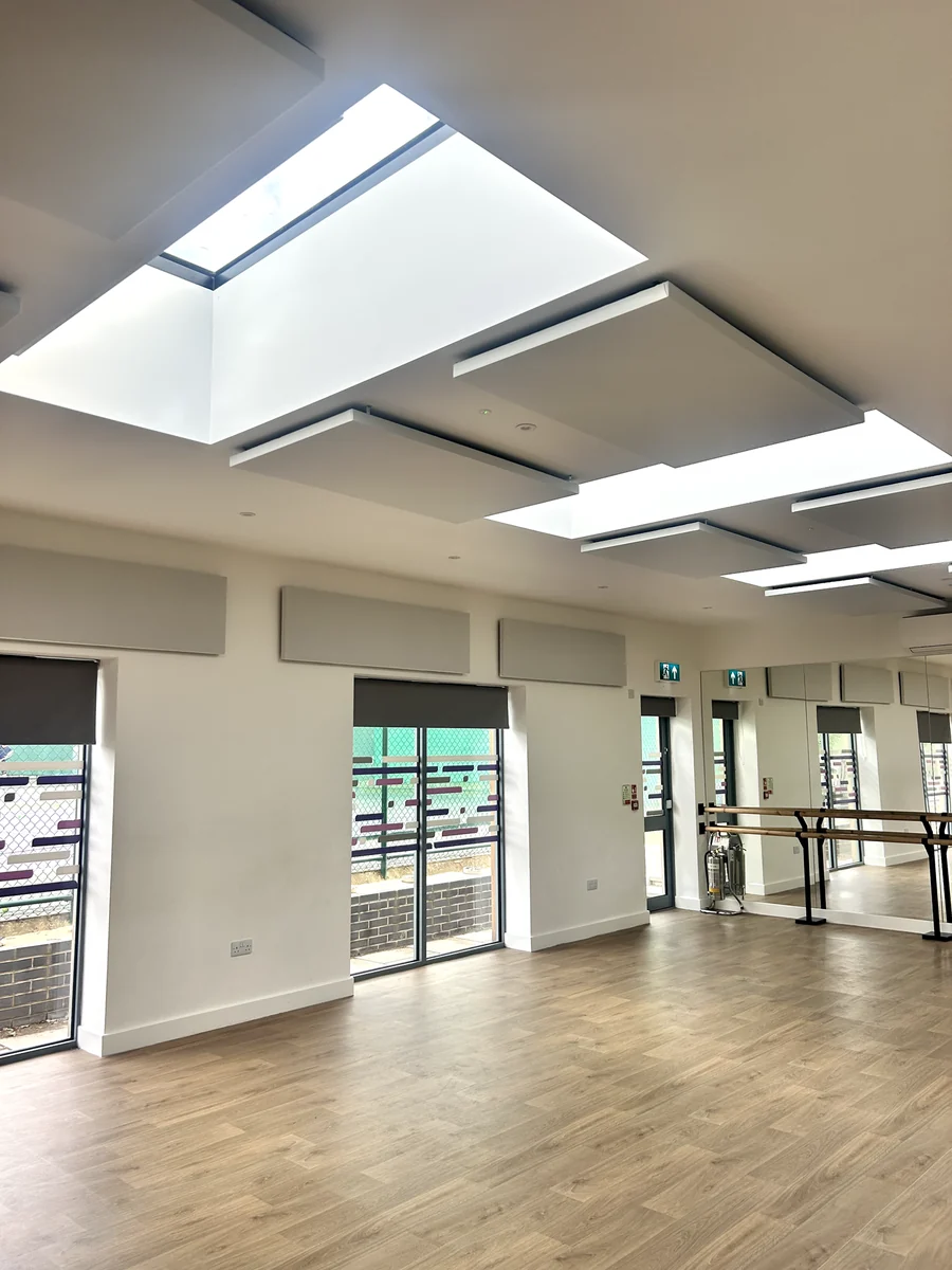 Acoustic ceiling panels around rooflights above the wooden floor of Poppleton Community Centre dance studio.