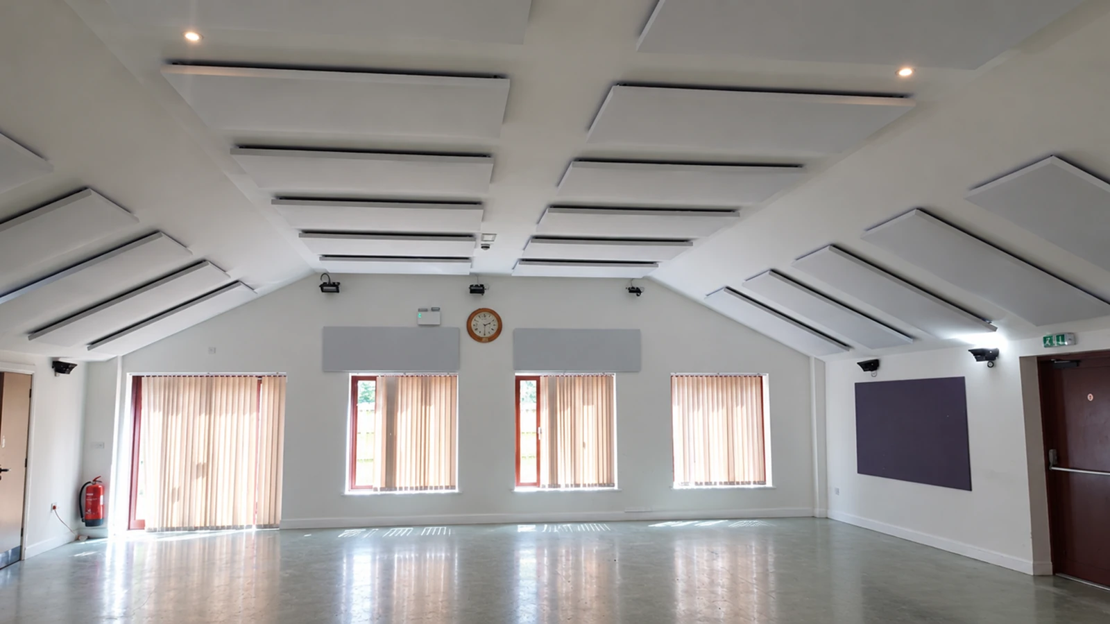 Grey acoustic panels fitted across the sloped ceiling and around the walls of St Margaret’s Church Centre hall.