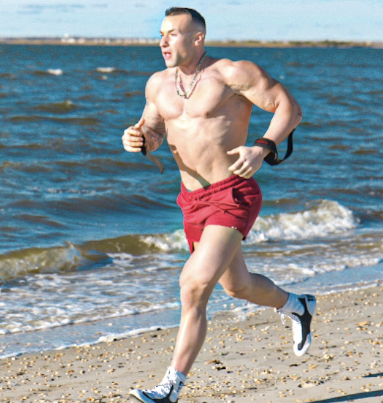 Coach Pauly running on the beach