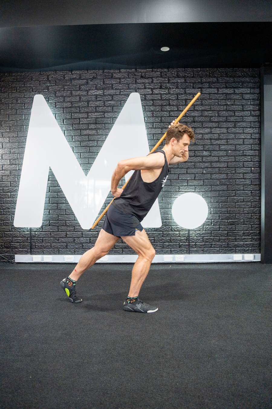 Sam Stow demonstrating a hip hinge movement pattern used to build efficient running mechanics