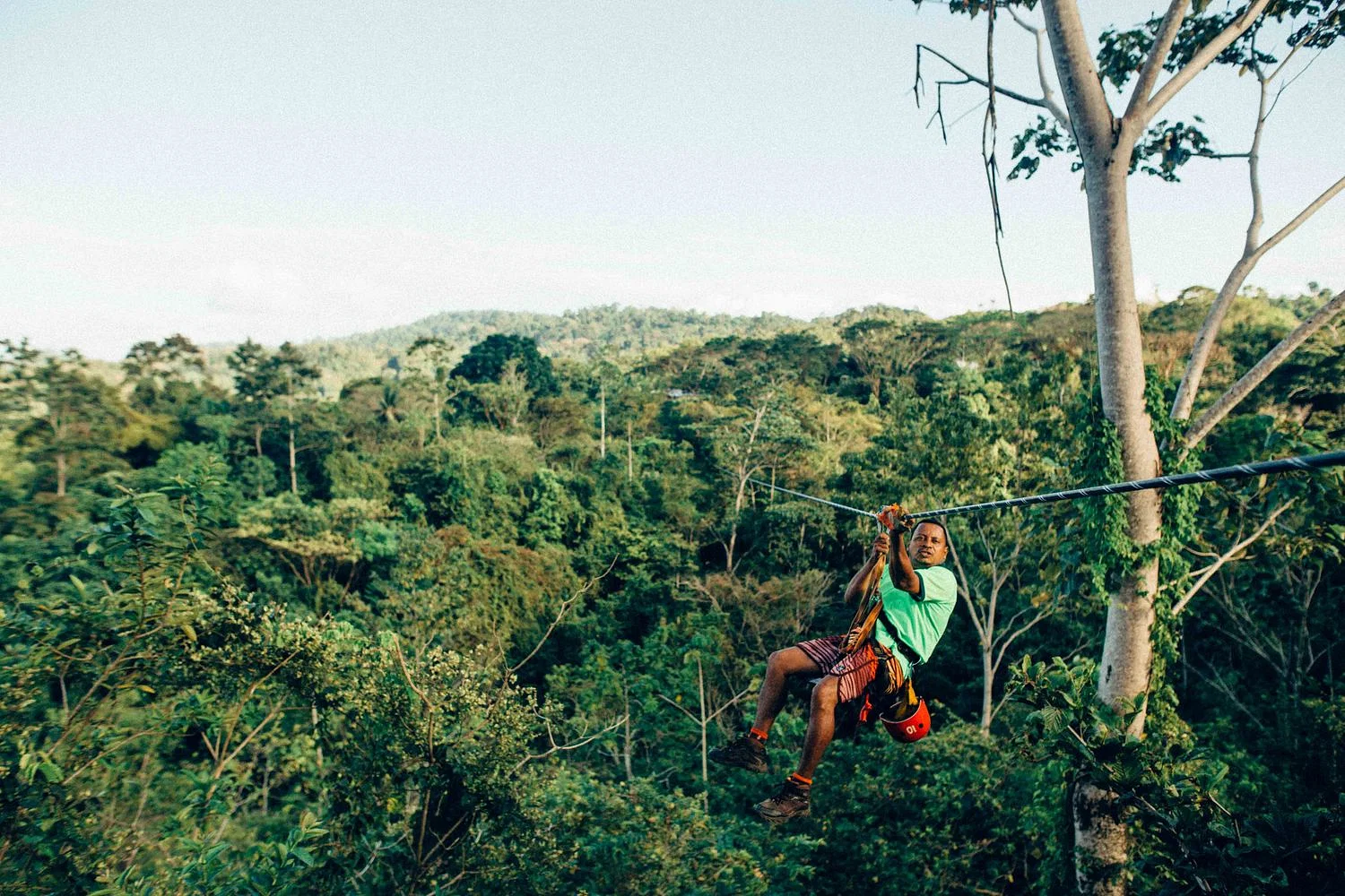a person standing on a rock in a canyon