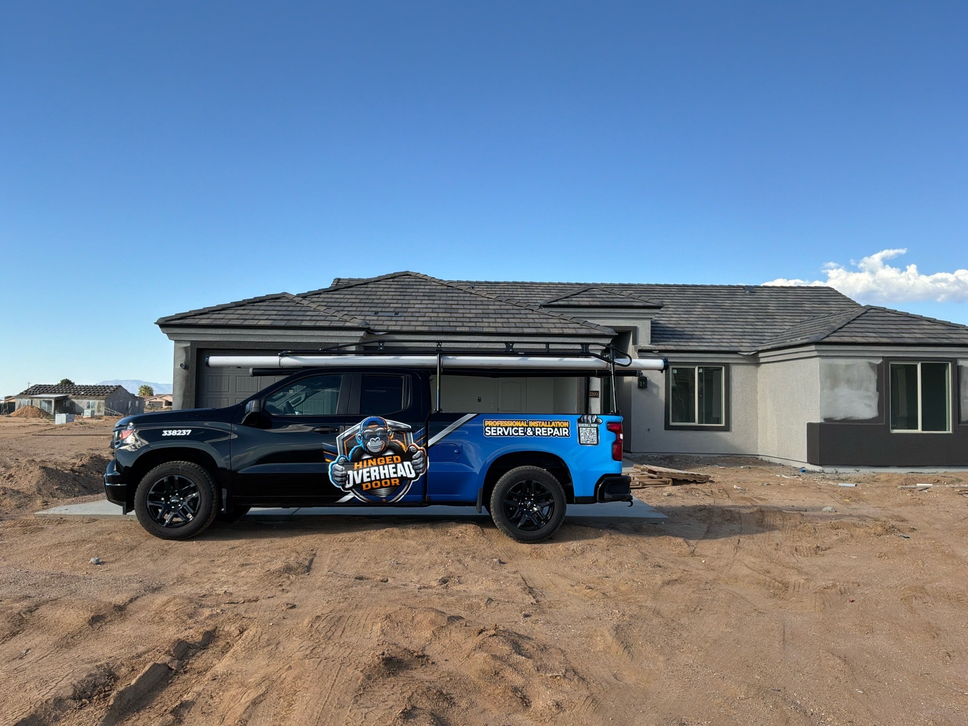 Hinged Overhead Door service truck at a residential jobsite