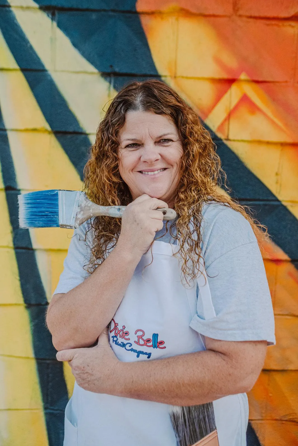 Photo of Cindi Stawicki holding a paint brush