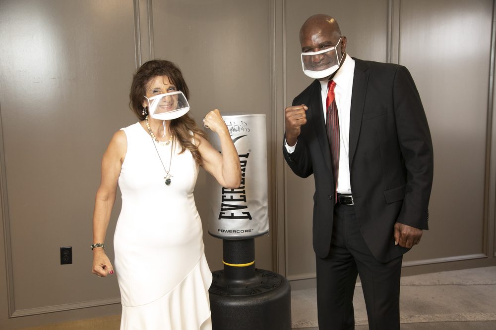 Dr. Dalal Akoury shares a playful moment with boxing champion Evander Holyfield
