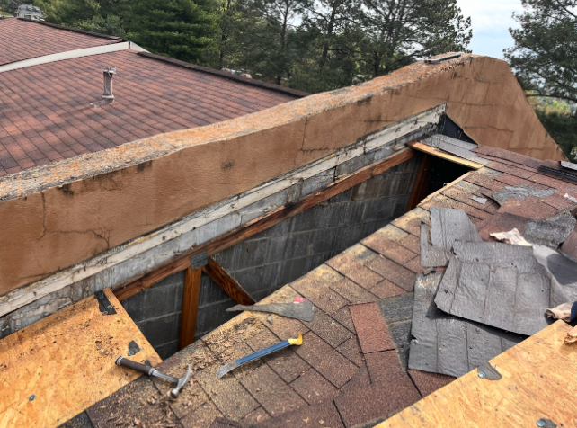 Roof opened up to expose decking — diagnosing leaks and underlying damage