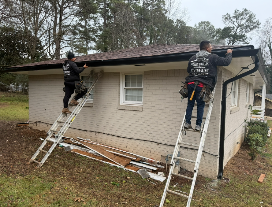 CW2 crew working on gutters and roof edge of a residential home
