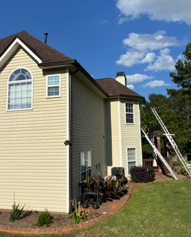 Cream-sided home receiving new siding installation by CW2 Renovations