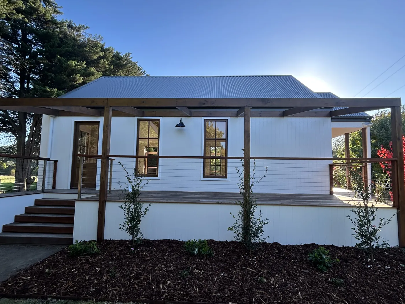 Cottage at Immerse Winery after ABM Painting, crisp white walls and finished timber
