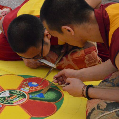Buddhist monks creating mandalas.