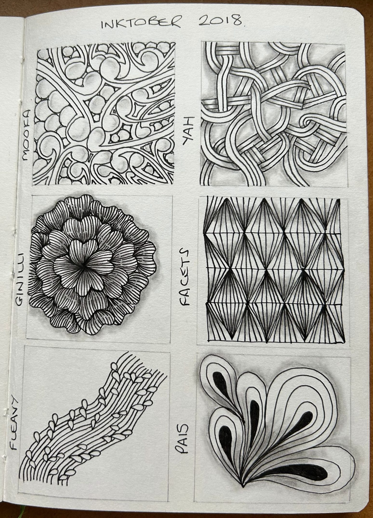 A sketch book opened at a page showing tangles created for Inktober Tangles 2018 A sketch book opened at a page showing tangles created for Inktober Tangles 2018