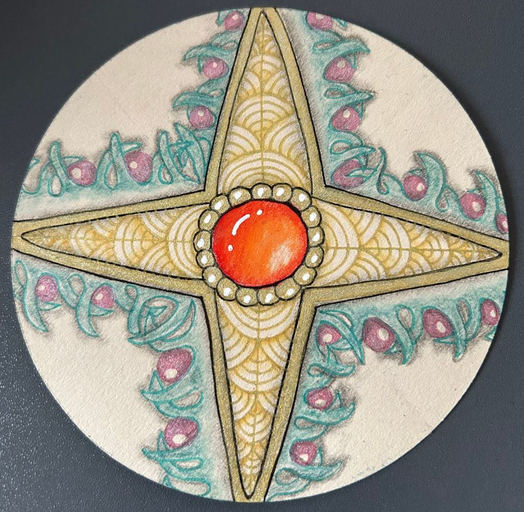 Festive Zentangle Christmas Compass Rose drawn by Lisa Crow CZT surrounded by various art supplies used to create the tile.