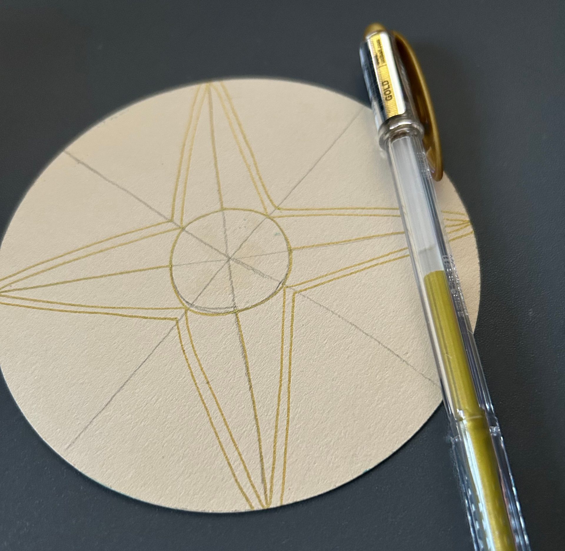 Lisa Crow's Christmas Compass Rose tile at the stage where she has drawn the tangle in gold and aured the whole shape.