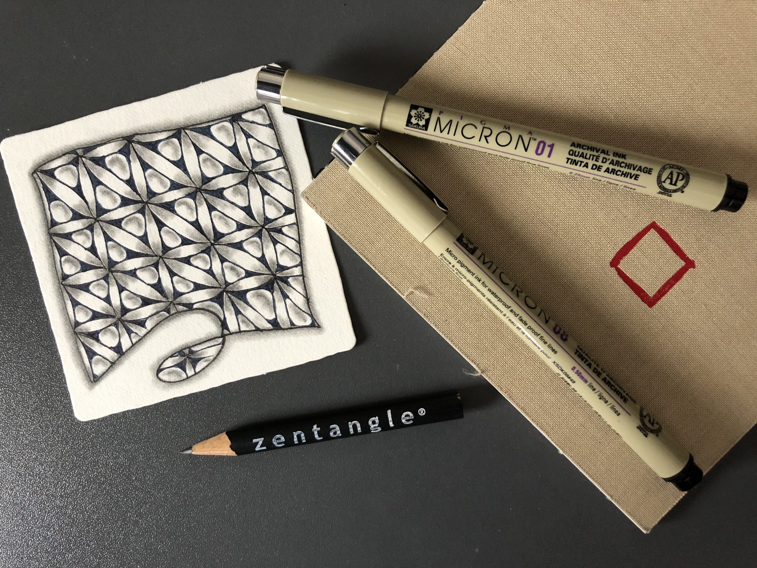 Image of micron pens, a Zentangle tile and a Zentangle booklet and pencil. Displayed on the Lessons page of the Wee Crafty Crow website Image of micron pens, a Zentangle tile and a Zentangle booklet and pencil. Displayed on the Lessons page of the Wee Crafty Crow website